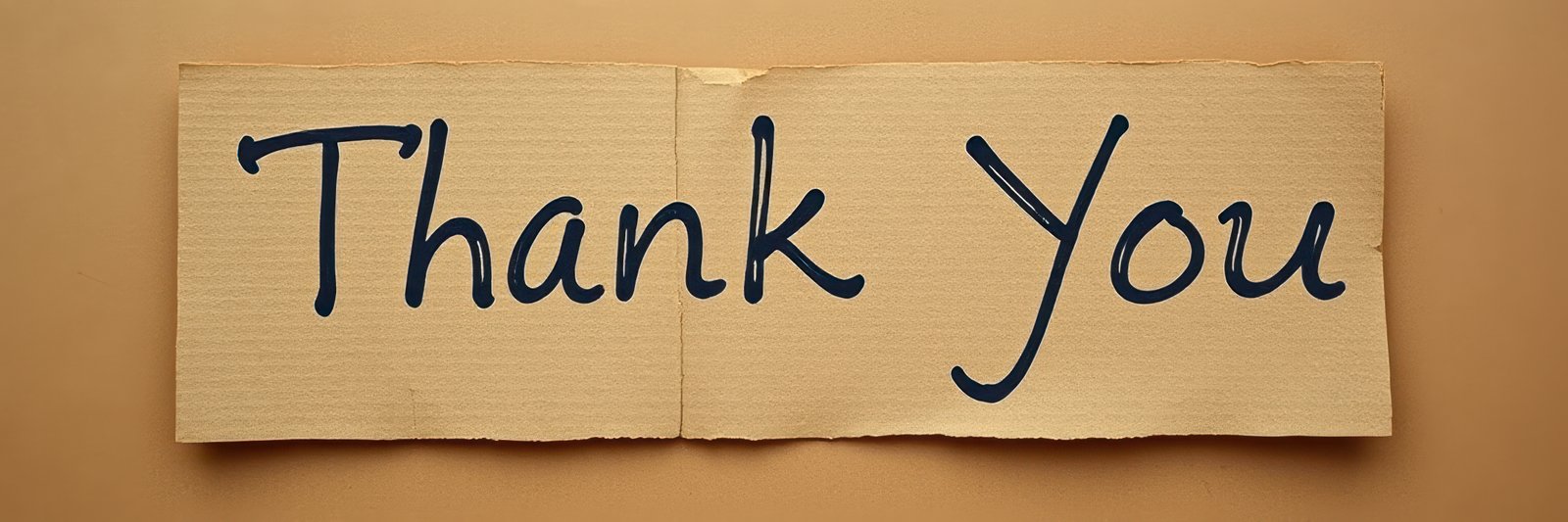 Rustic thank you note on cardboard expressing gratitude in simple yet heartfelt manner